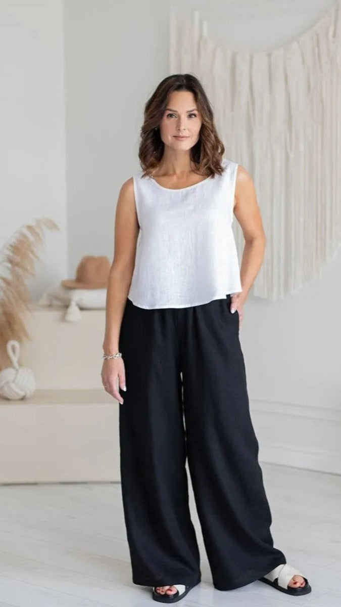 Woman standing wearing relaxed linen black pant 