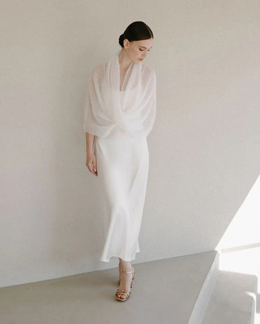 Woman wearing white fine knit mohair shawl in white.