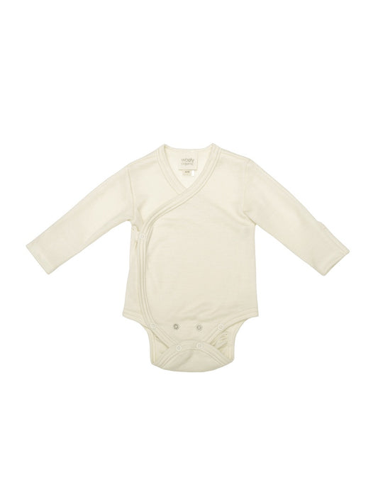 Cream merino wool baby bodysuit with long sleeves and snap buttons, laid flat on white background