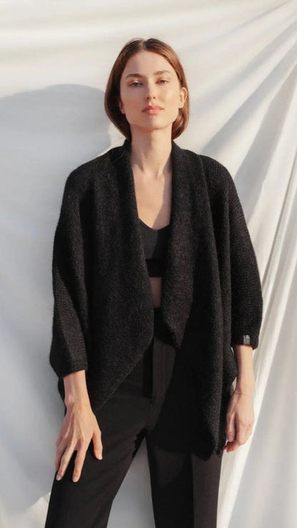 Woman wearing black poncho