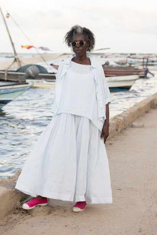Woman wearing linen top with collar and shell button front.