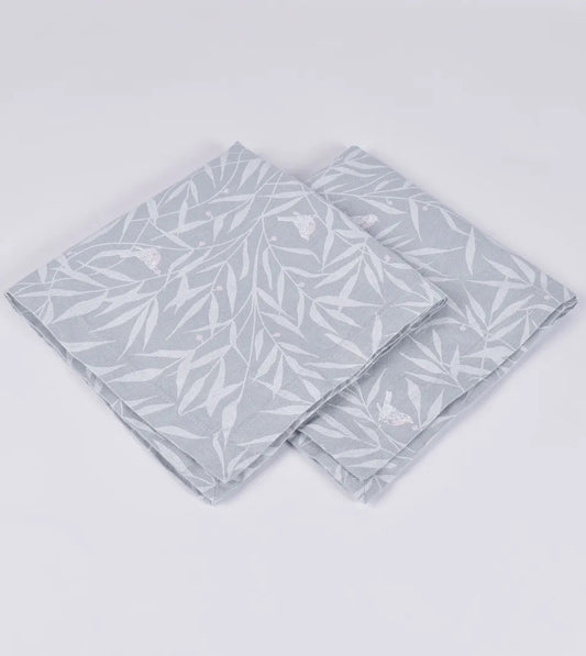 Set of four pale blue linen napkins with leaf design.