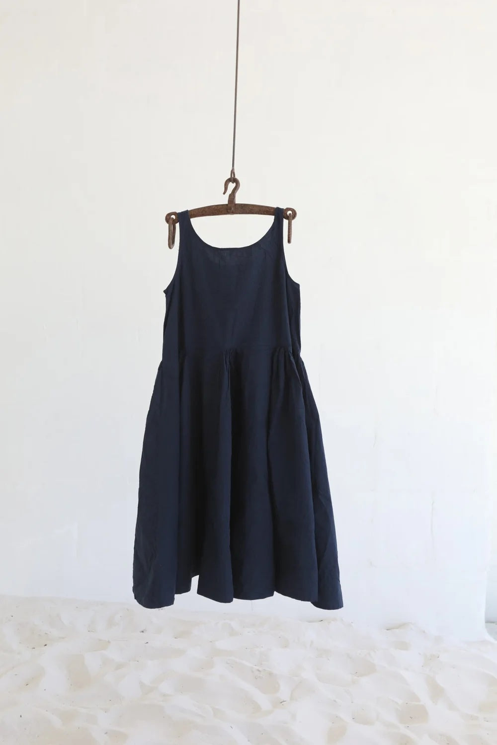 Indigo Cotton poplin dress with scooped neck and wide gathered skirt on mannequin.