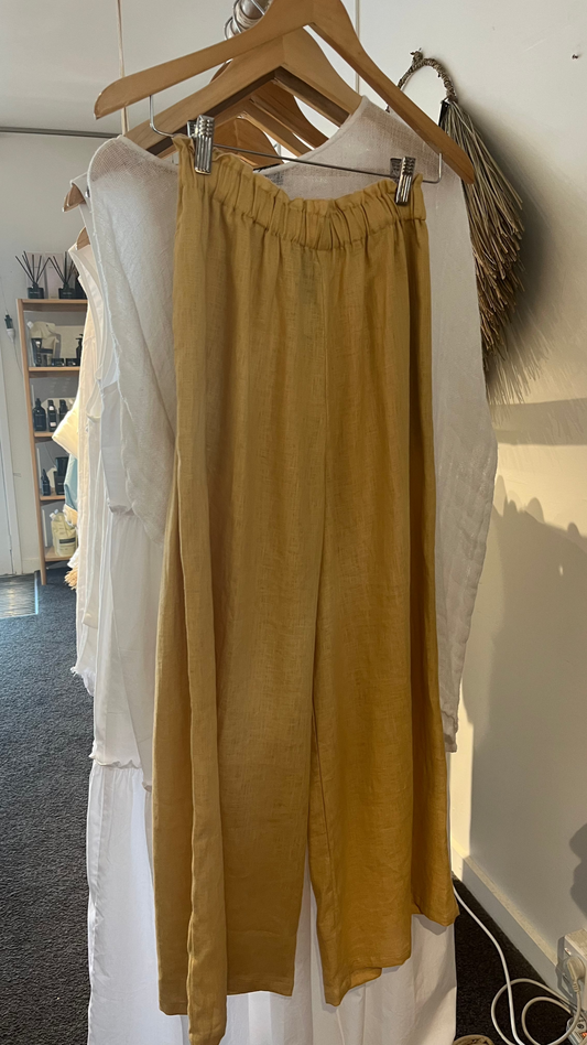 Tan linen pant with wide leg and elastic waist on hanger.