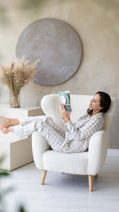 woman sitting on a chair in pyjamas