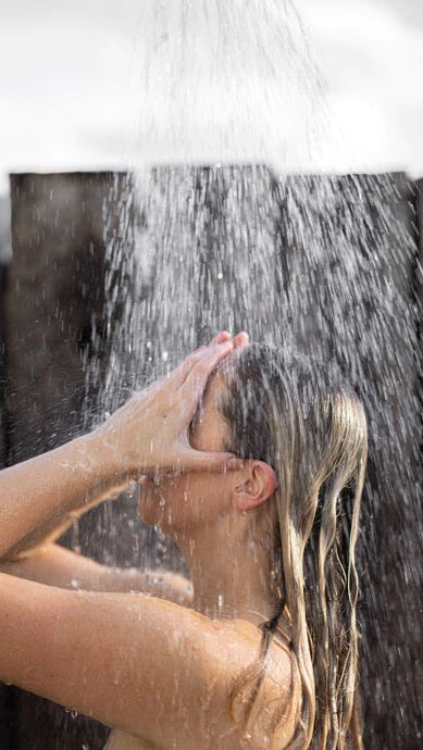Woman washing hair under shower, wet hair care, personal hygiene concept