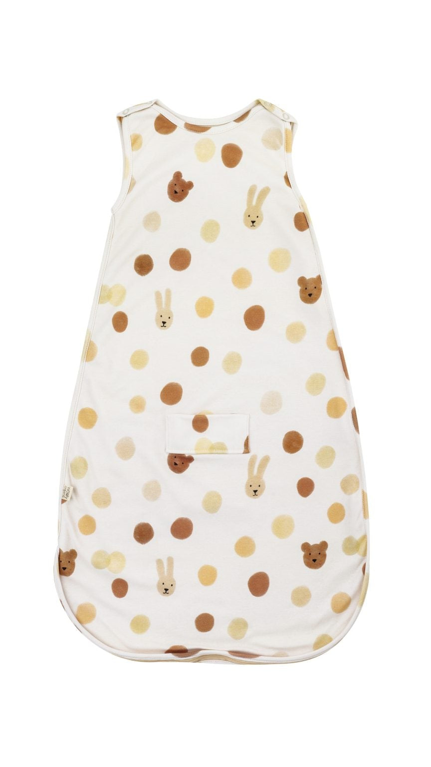 Baby sleeping bag with bear and bunny faces and beige polka dot pattern on white fabric