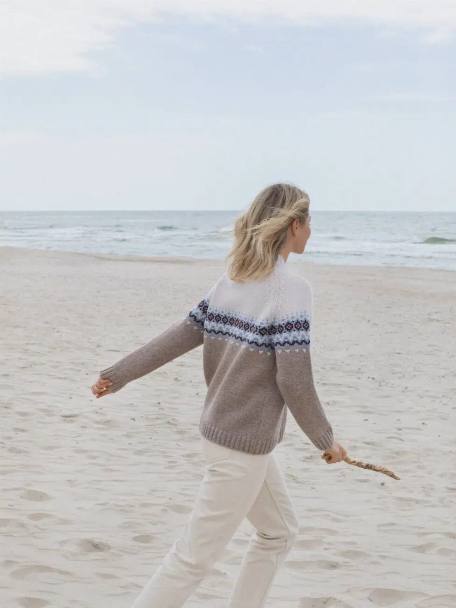 Woman wearing two tone nordic sweater back view