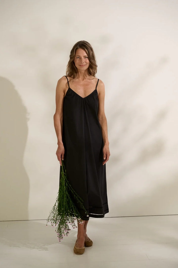 Woman wearing black cotton poplin sun dress