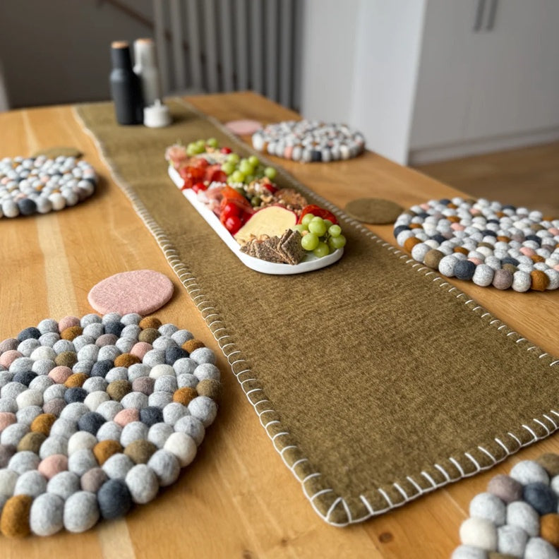 Ochre felted table runner in ochre with contrast white blanket stitch edging.
