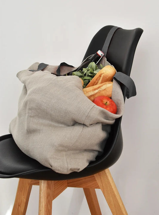 linen tote bag filled with groceries on chair