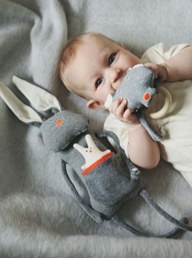 Baby holding Wolf teething ring