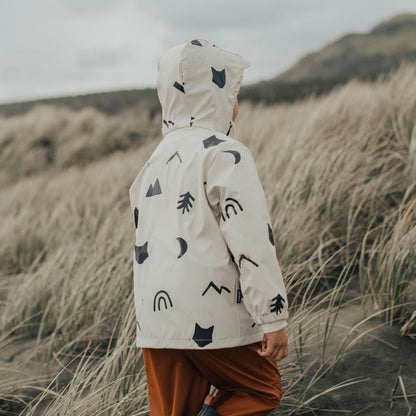 child wearing a waterproof jacket white and black patterns