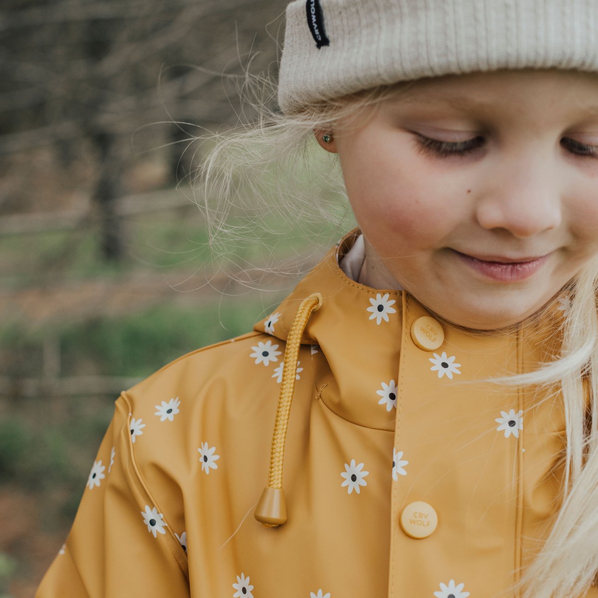 close up of waterproof kids jacket yellow with white flowers