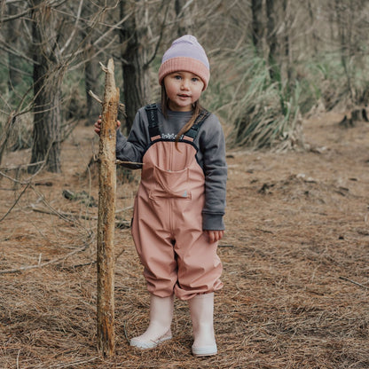 girl wearing waterproof overalls pink front