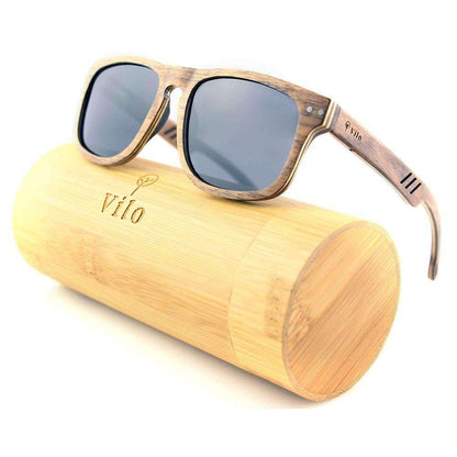 Wooden sunglasses with dark lenses resting on a bamboo sunglasses case