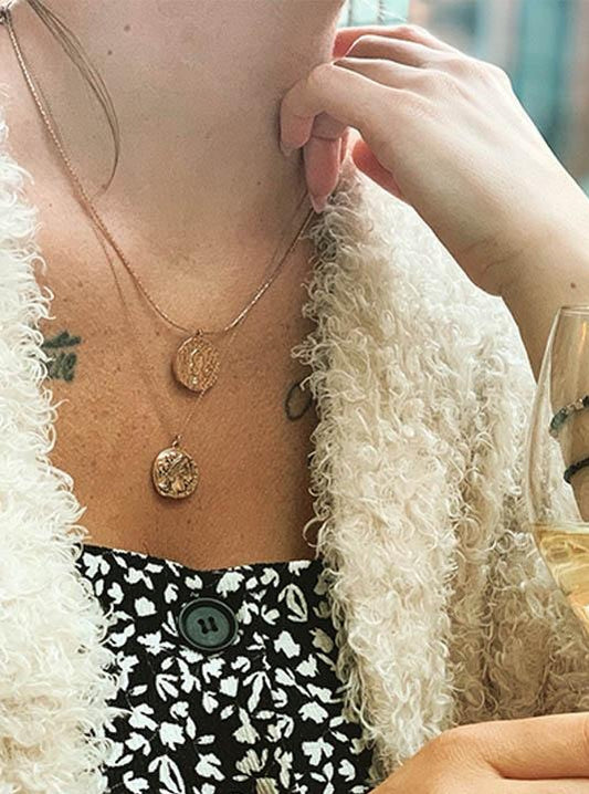 Lady wearing horoscope necklaces