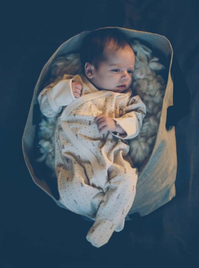 Baby wearing organic cotton sleepsuit