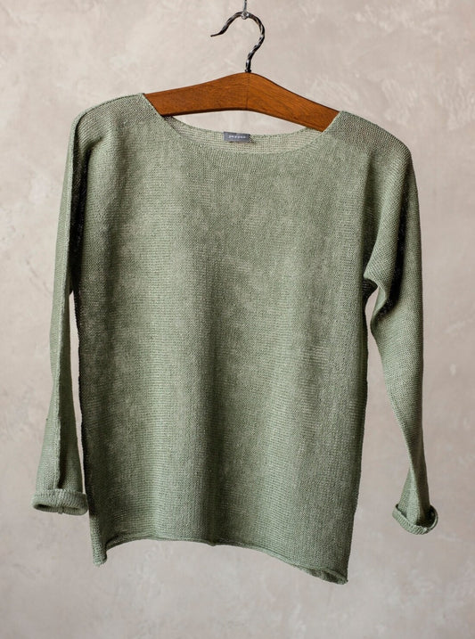 green knitted linen sweater on hanger